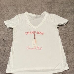 White V-Neck Tee with Pink 'Champagne Social Club' Graphic